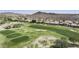 Panoramic aerial view of golf course and the surrounding mountains, blending recreation with scenic beauty at 16008 S 13Th Way, Phoenix, AZ 85048