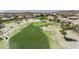 Stunning aerial view of a well-manicured golf course, showcasing lush green fairways and sand traps at 16008 S 13Th Way, Phoenix, AZ 85048