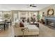 Open-concept living room featuring bar stool seating, fireplace, natural light, and comfortable sectional sofa at 16008 S 13Th Way, Phoenix, AZ 85048