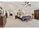 Vaulted ceiling, ceiling fan, and neutral decor create a calming atmosphere in this beautiful main bedroom at 16008 S 13Th Way, Phoenix, AZ 85048