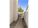 Side yard walkway with brick pavers, desert landscaping, and a view of backyard trees at 16008 S 13Th Way, Phoenix, AZ 85048