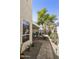 Side yard walkway with brick pavers, desert landscaping, and a view of the back patio at 16008 S 13Th Way, Phoenix, AZ 85048