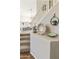 Carpeted staircase with white railing, complemented by decorative bowls, creating an elegant transition between floors at 16008 S 13Th Way, Phoenix, AZ 85048