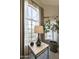 Bright window with sheer curtains, complemented by a decorative table and potted plants, adding natural light at 16008 S 13Th Way, Phoenix, AZ 85048