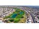 Aerial view showcasing a well-manicured golf course winding through a residential community with lush greenery at 16014 W Kino Dr, Surprise, AZ 85374