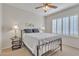 Bedroom with neutral walls features plantation shutters and ceiling fan at 16014 W Kino Dr, Surprise, AZ 85374