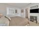 Carpeted bedroom features a large bed, plantation shutters, and an en-suite bathroom at 16014 W Kino Dr, Surprise, AZ 85374