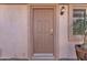 Front door with sidelight and mature landscaping at 16014 W Kino Dr, Surprise, AZ 85374