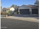 Charming home featuring desert landscaping, three-car garage, and a terracotta tile roof at 16488 W Windsor Ave, Goodyear, AZ 85395