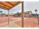 Backyard scene under a covered patio featuring desert landscaping and exterior home view at 1668 E Valerie St, Casa Grande, AZ 85122