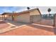 Wide backyard view showcasing a covered patio, a secure fence, and minimal landscaping at 1668 E Valerie St, Casa Grande, AZ 85122