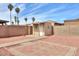 A backyard view showing a shed-style structure set against a desert landscape and block wall at 1668 E Valerie St, Casa Grande, AZ 85122