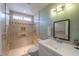 Well-lit bathroom with a walk-in shower featuring neutral tile, grab bars, and modern fixtures at 1668 E Valerie St, Casa Grande, AZ 85122