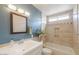 A well-lit bathroom has stylish tile work around the tub and a framed mirror above the sink at 1668 E Valerie St, Casa Grande, AZ 85122