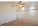 Bedroom with wood floors, ceiling fan and closet doors at 1668 E Valerie St, Casa Grande, AZ 85122