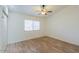 Bedroom featuring a ceiling fan, wood floors, and a window at 1668 E Valerie St, Casa Grande, AZ 85122