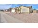 Front exterior view of a single-story home with low-maintenance desert landscaping at 1668 E Valerie St, Casa Grande, AZ 85122