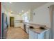 Bright kitchen featuring granite countertops, white cabinets, stainless steel appliances, and wood floors at 1668 E Valerie St, Casa Grande, AZ 85122