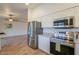 Modern kitchen featuring stainless steel appliances, white cabinets, and granite countertops at 1668 E Valerie St, Casa Grande, AZ 85122