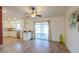 Open living room featuring wood floors, sliding glass doors and kitchen access at 1668 E Valerie St, Casa Grande, AZ 85122