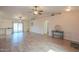 Bright and airy living room with wood-look flooring featuring a view of the kitchen and sliding glass door at 1668 E Valerie St, Casa Grande, AZ 85122