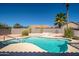 Backyard pool with a sun-drenched patio and desert landscaping at 17768 W Maui Ln, Surprise, AZ 85388