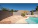 Backyard patio area leading to a refreshing pool with mature desert landscaping at 17768 W Maui Ln, Surprise, AZ 85388