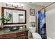 Bathroom with a vessel sink, framed mirror, colorful shower curtain, and toilet, offering style and functionality at 17801 N 43Rd Way, Phoenix, AZ 85032