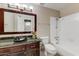 Bathroom with a dark vanity, a vessel sink, a bathtub, a shower, tile floor, and neutral paint at 17801 N 43Rd Way, Phoenix, AZ 85032