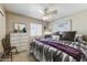 Bedroom featuring neutral walls, ceiling fan, window with blinds, a dresser, and a comfortable-looking bed at 17801 N 43Rd Way, Phoenix, AZ 85032