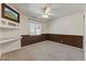 Cozy bedroom featuring neutral carpet, ceiling fan, and built-in shelving with a TV at 17801 N 43Rd Way, Phoenix, AZ 85032