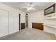 Inviting bedroom complete with neutral carpet, ceiling fan, and built-in shelving with a TV at 17801 N 43Rd Way, Phoenix, AZ 85032