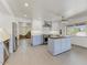 Bright kitchen with white and blue cabinets, a butcher block island, stainless steel appliances, and views of the living area at 17801 N 43Rd Way, Phoenix, AZ 85032