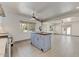 Kitchen island with butcher block top, white cabinets, stainless steel appliances, and views of the living area at 17801 N 43Rd Way, Phoenix, AZ 85032