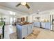 Elegant open-concept kitchen with stainless steel appliances, white cabinets, and an island with wood countertop at 17801 N 43Rd Way, Phoenix, AZ 85032