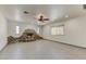 Living room with rock fireplace, neutral paint, recessed lighting, and a ceiling fan, creating a cozy atmosphere at 17801 N 43Rd Way, Phoenix, AZ 85032