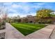 Lush green backyard with manicured lawn and mature landscaping at 17902 N 93Rd Way, Scottsdale, AZ 85255