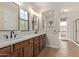 A modern bathroom with double sinks, a window, and an exit to a patio at 17902 N 93Rd Way, Scottsdale, AZ 85255