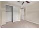 Neutral bedroom with ceiling fan, opened closet doors, and view to hallway at 17902 N 93Rd Way, Scottsdale, AZ 85255