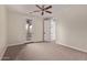 This bedroom features carpet and a ceiling fan, with access to a balcony and hallway at 17902 N 93Rd Way, Scottsdale, AZ 85255