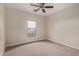 Neutral bedroom with a ceiling fan and a window providing natural light at 17902 N 93Rd Way, Scottsdale, AZ 85255