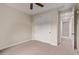 Neutral bedroom with ceiling fan, closet with doors, and open view to hallway at 17902 N 93Rd Way, Scottsdale, AZ 85255