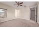 A spacious bedroom with neutral walls, carpet, and access to a balcony at 17902 N 93Rd Way, Scottsdale, AZ 85255