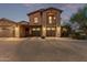 Spacious home with a three-car garage, stone accents, and a well-maintained driveway, offering ample parking and curb appeal at 17902 N 93Rd Way, Scottsdale, AZ 85255