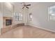 Inviting living room featuring a cozy fireplace and lots of natural light at 17902 N 93Rd Way, Scottsdale, AZ 85255