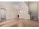 Open living room area with tile flooring and staircase at 17902 N 93Rd Way, Scottsdale, AZ 85255