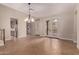 Expansive living area featuring tile floors, grand lighting, and access to the balcony at 17902 N 93Rd Way, Scottsdale, AZ 85255