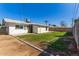 View of the backyard featuring a grass lawn with landscaping along the block fence at 1827 E Jarvis Ave, Mesa, AZ 85204