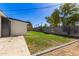 View of the backyard featuring a grass lawn with concrete walkway and block wall fence at 1827 E Jarvis Ave, Mesa, AZ 85204