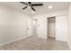 Bedroom features wood-look tile flooring, ceiling fan, and an open closet at 1827 E Jarvis Ave, Mesa, AZ 85204